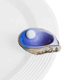 Nora Fleming Shuck Yeah oyster shell mini on a coastal display, hand-painted ceramic charm