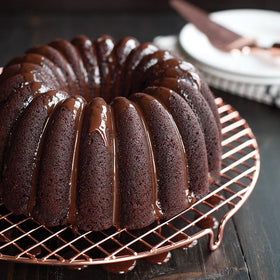 Nordic Ware copper-plated wire grid showcased with layered cakes