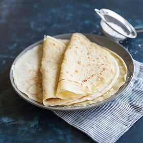 Nordic Ware crepe pan in-use image showing even cooking of eggs