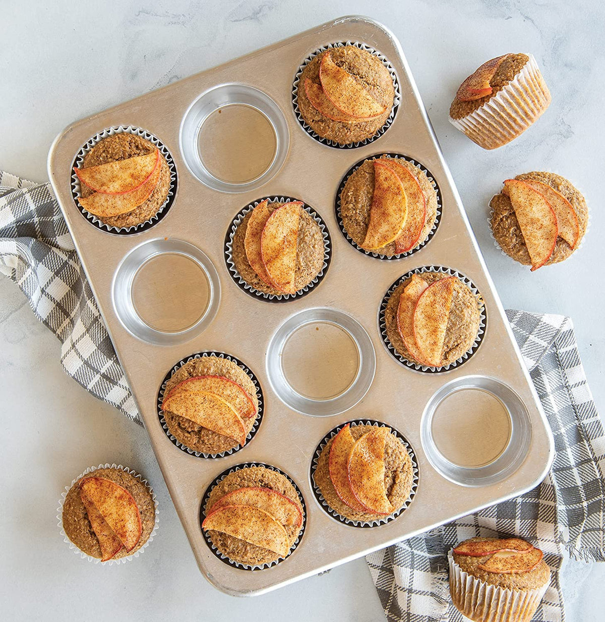 Nordic Ware muffin pan with baked muffins showing even rise and golden color