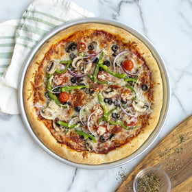 Nordic Ware Naturals 14-inch pizza pan side view shows sturdy, warp-resistant bakeware