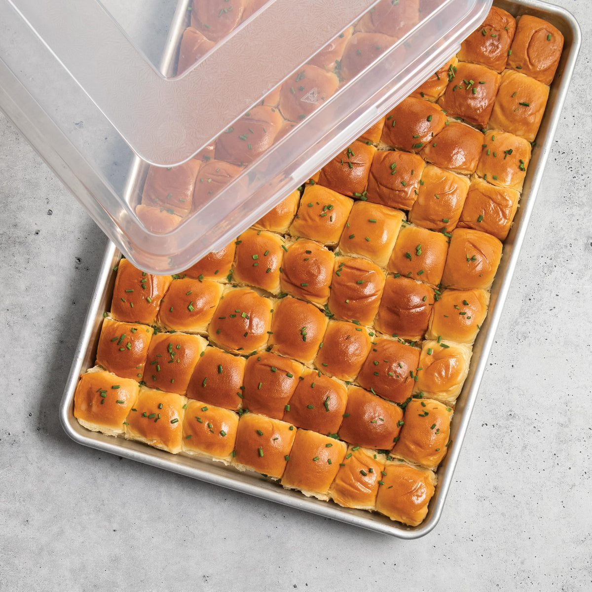 Nordic Ware Naturals Big Batch Pan with lid, keeps baked goods fresh during transport.