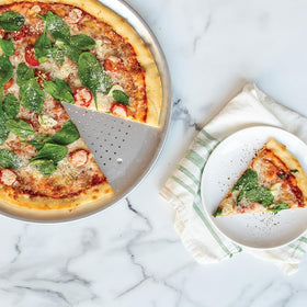 Nordic Ware Naturals 16-inch perforated pan in use, evenly browning crust.