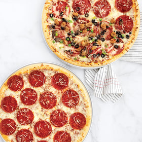 Nordic Ware Naturals two-pan set stacked, ready for family pizza night.