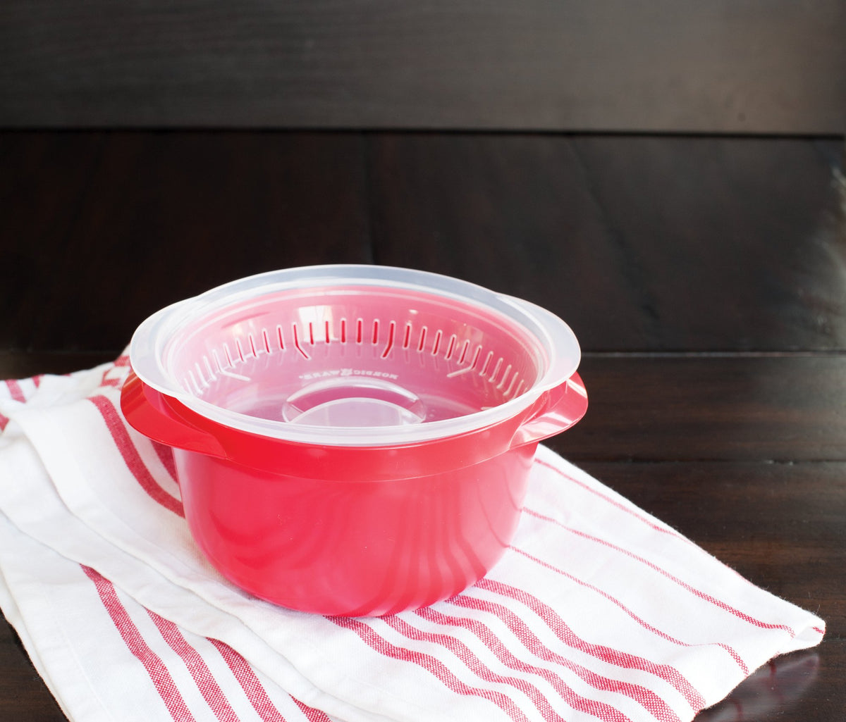 Nordic Ware lid doubles as a perforated strainer to prevent boil-overs