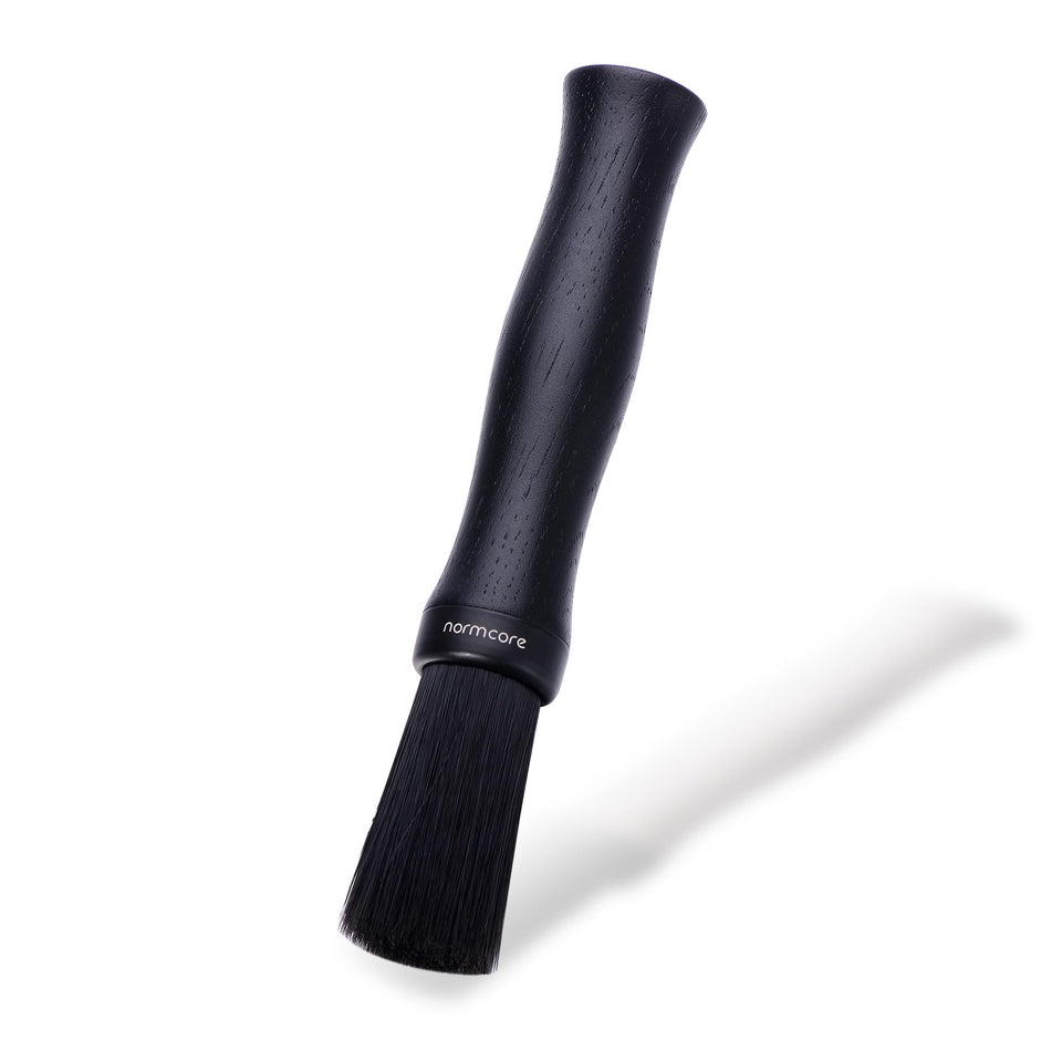 Normcore Barista Brush with oak wood handle for precise coffee grounds cleaning.