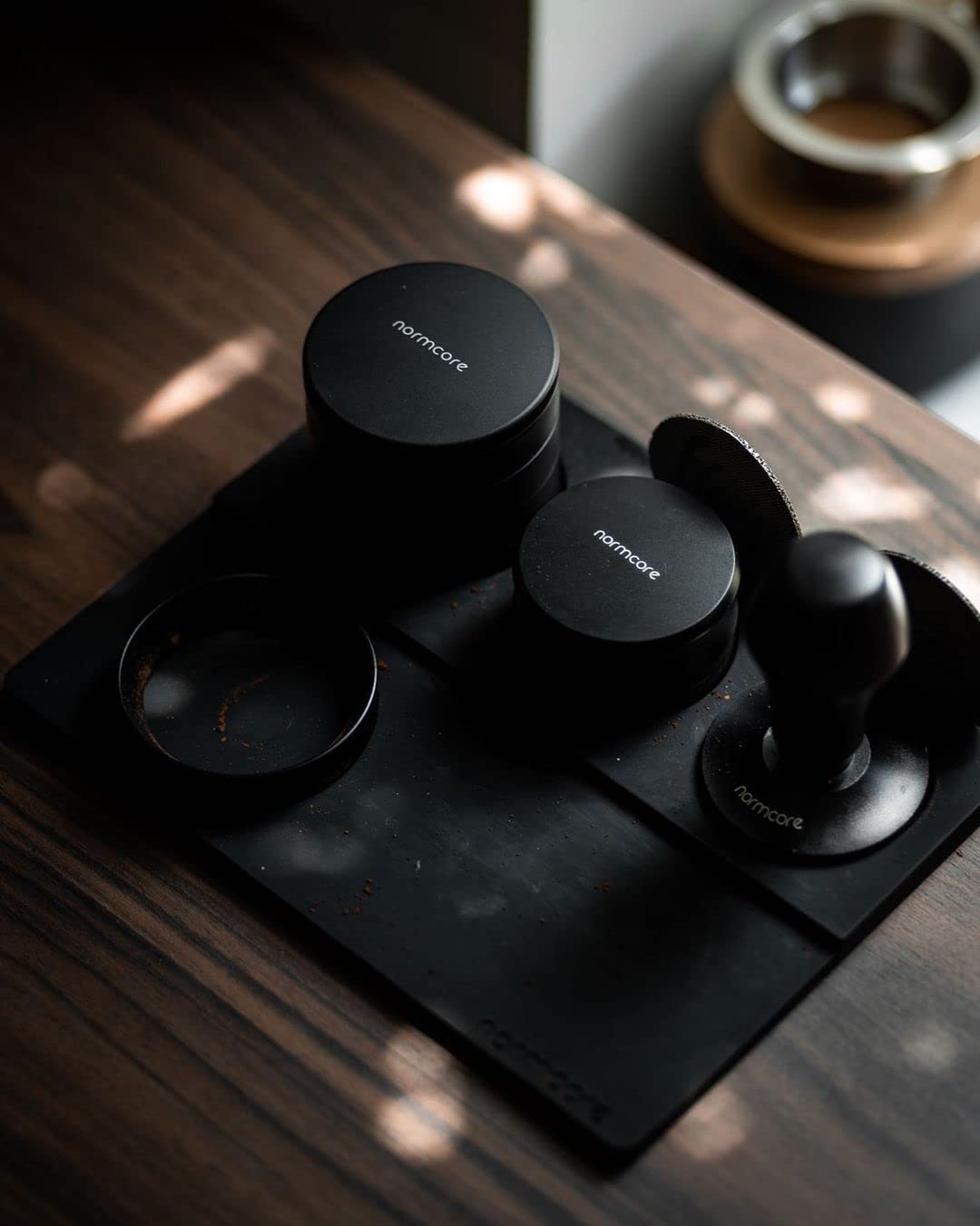 Normcore Built-In Tamp Stand holds your tamper within reach for quick switching.