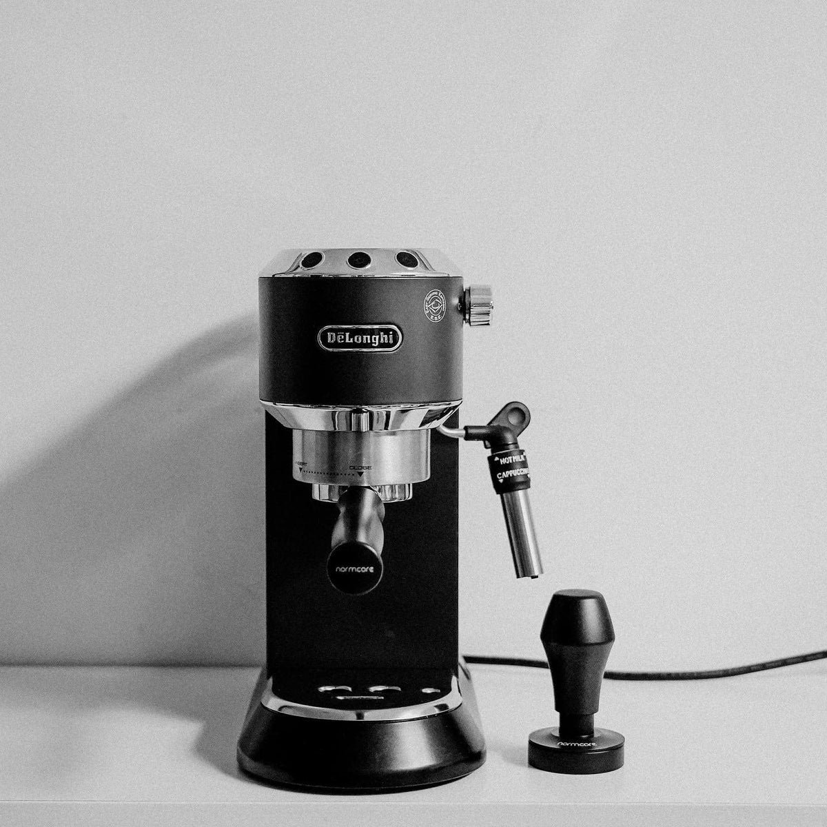Normcore leveling plate ensures uniform tamping across the filter basket