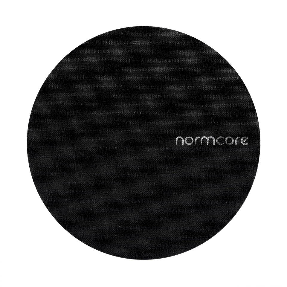 Normcore puck screen with titanium coating; close-up shows a durable, corrosion-resistant surface for espresso prep.