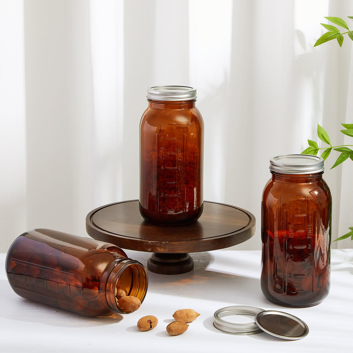 Norme amber jar filled with beverages and herbs for display.