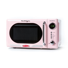 Nostalgia microwave pink front view showing retro style and compact footprint for small kitchens.