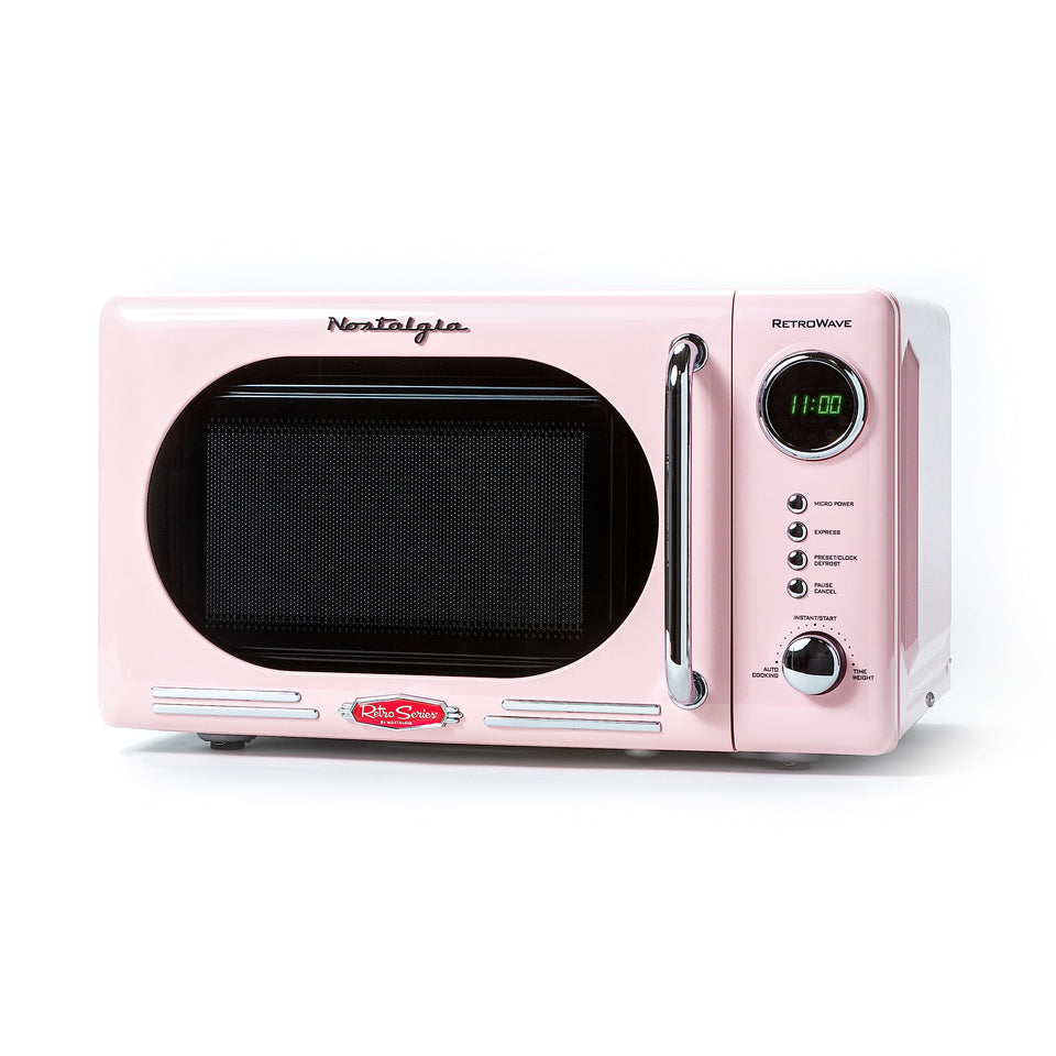 Nostalgia microwave pink front view showing retro style and compact footprint for small kitchens.