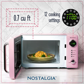 Nostalgia microwave pink LED display close-up highlights 12 pre-programmed settings.
