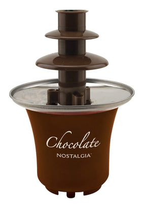 Nostalgia party table setup featuring a stylish fondue fountain for entertaining