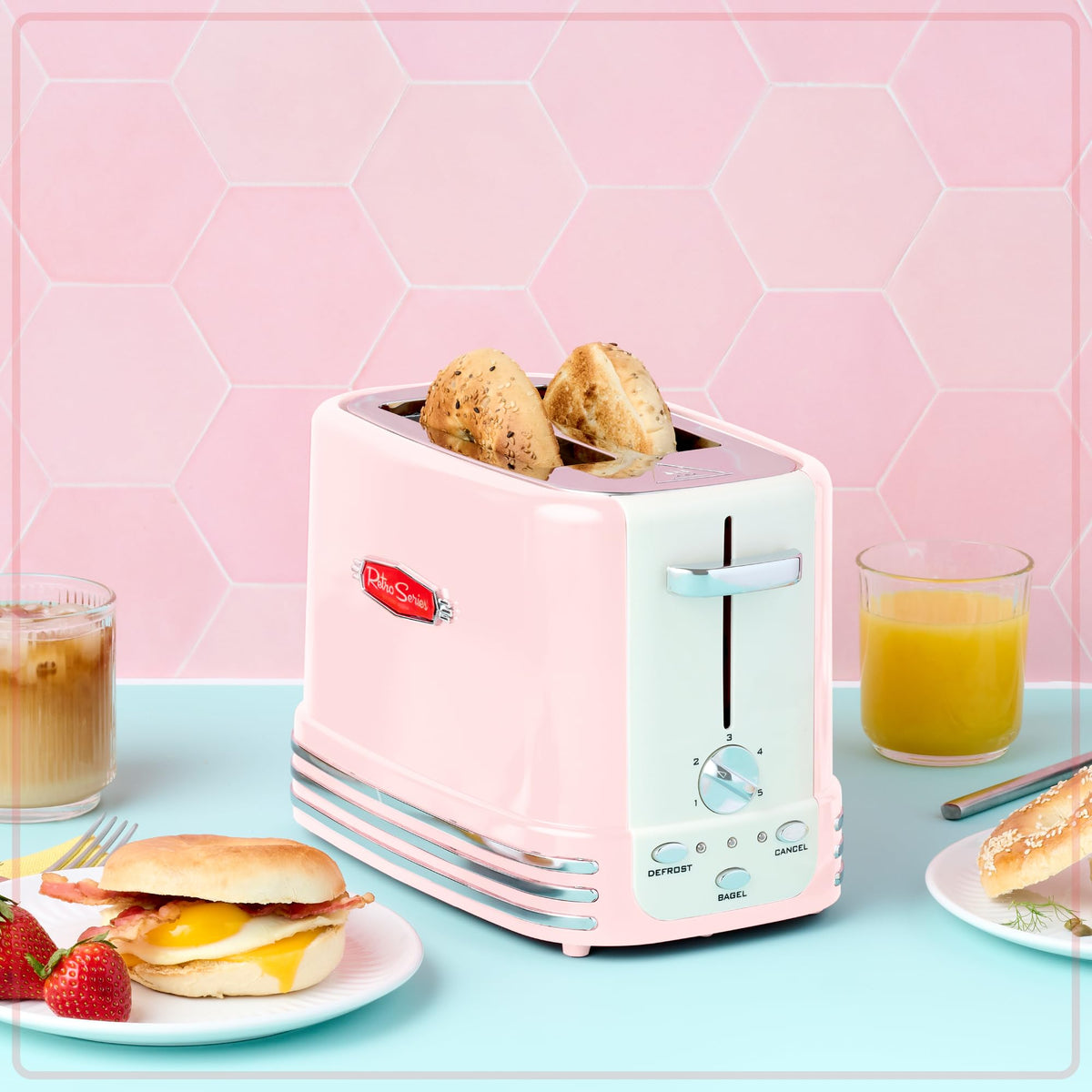 Nostalgia pink toaster illuminated controls for bagel, defrost, and cancel options