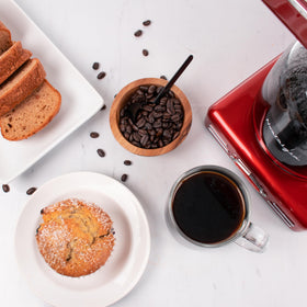 Nostalgia red coffee maker close-up emphasizes retro design and style.