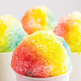 Nostalgia Snow Cone Machine with scoop showing compact storage for accessories.