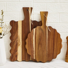 Novabright round acacia cutting board with handle, perfect for cheese and fruit service.