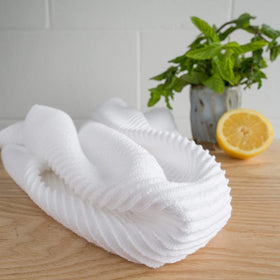 Now Designs Ripple White towels set of two, hanging by stove for easy reach