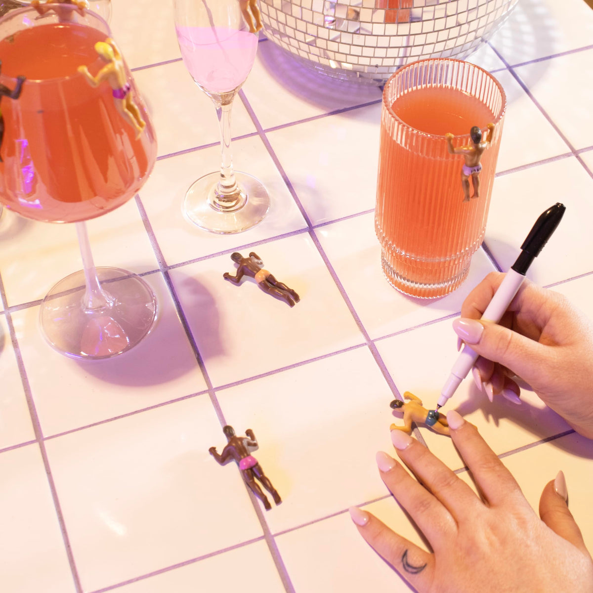 NPW Drinking Buddies pen close-up showing personalized labeling for each guest.