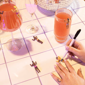 NPW Drinking Buddies pen close-up showing personalized labeling for each guest.