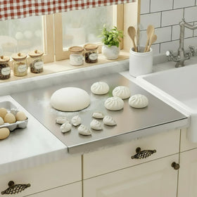 Oahtzy stainless steel cutting board with lip over sink for stable food prep.