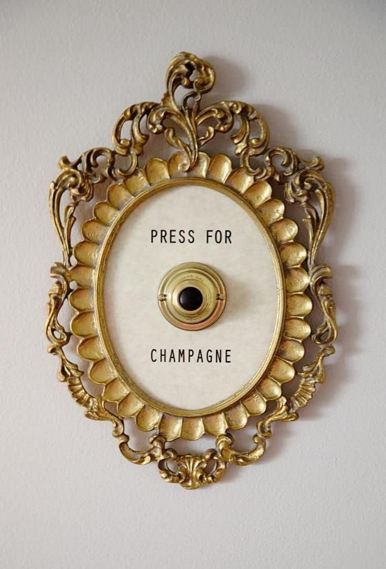 Okuorze champagne button frame in gold adds chic hotel vibes.