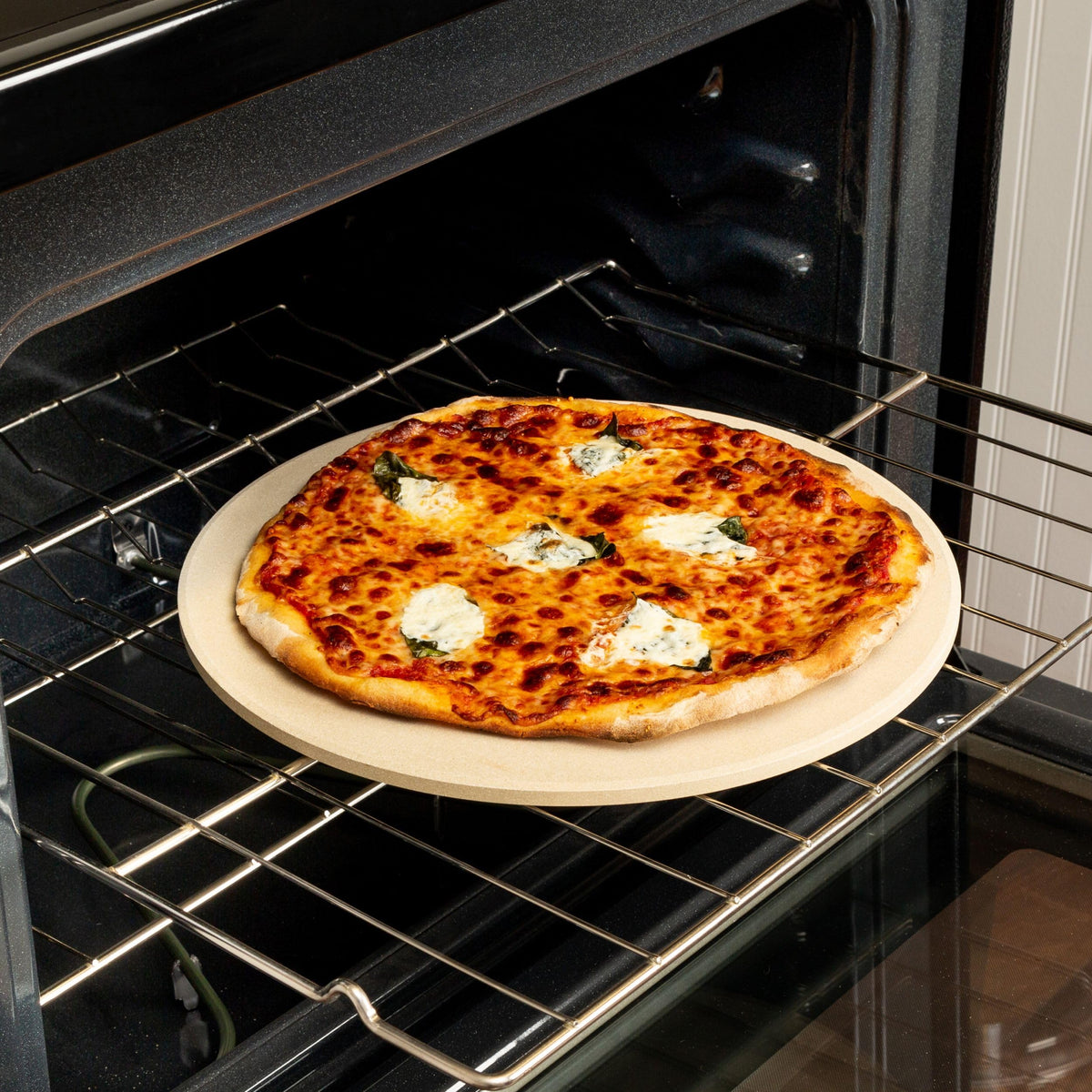 Old Stone 14-inch round pizza stone promotes even crust and tidy toppings.