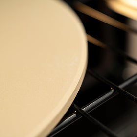 Old Stone Round Pizza Stone aids dough prep with even heat transfer.