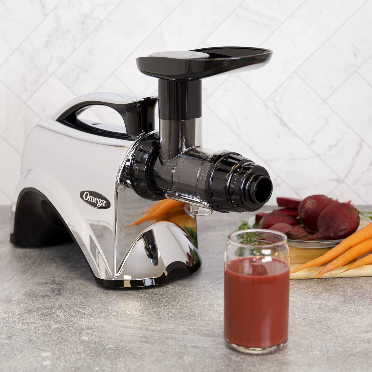 Omega NC900HD juicer feed tray in use for efficient juicing sessions.