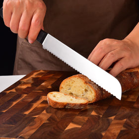 Omesata bread knife slicing crusty bread on board with minimal tearing