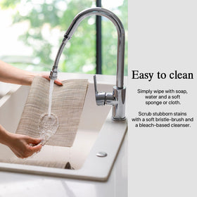 Onebento placemats being wiped clean for easy maintenance.