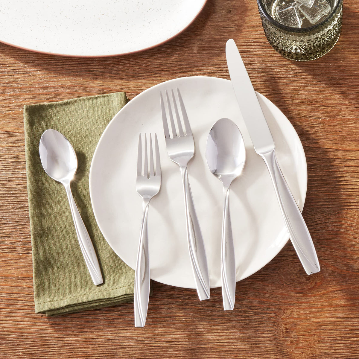 Oneida Camlynn Mirror handle swoop detail highlighting modern elegance.