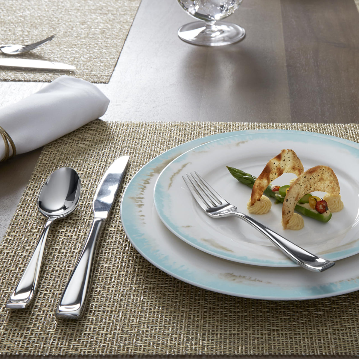 Oneida Moda teaspoons held in hand, showing balanced weight and refined form.