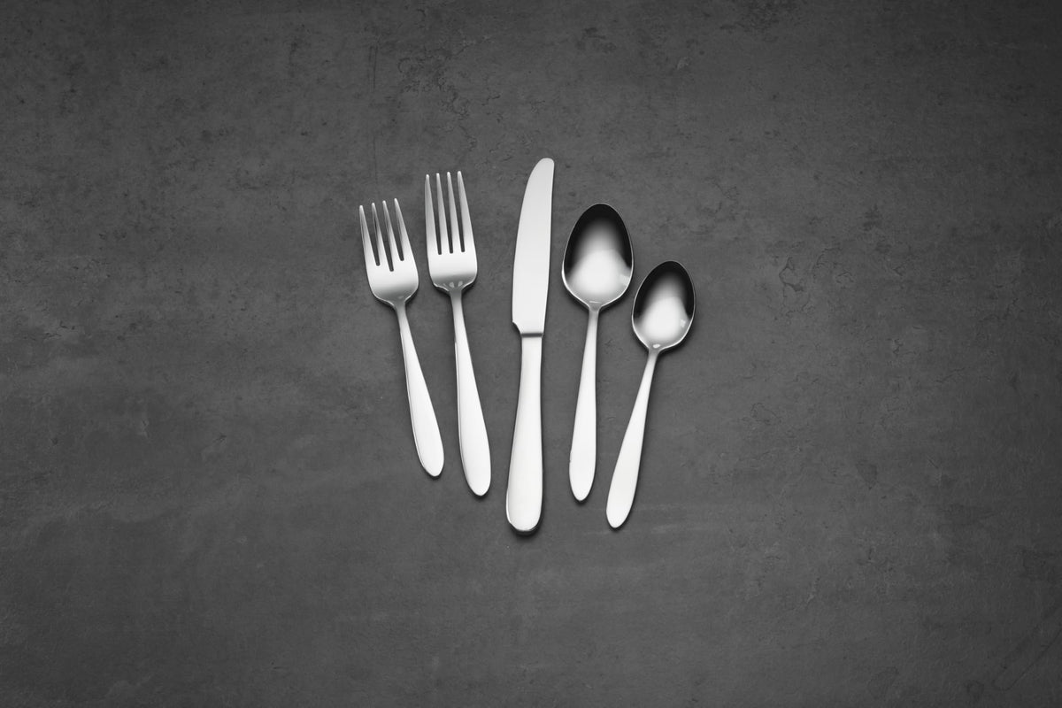 Oneida Mooncrest dinner fork in a coordinated place setting.