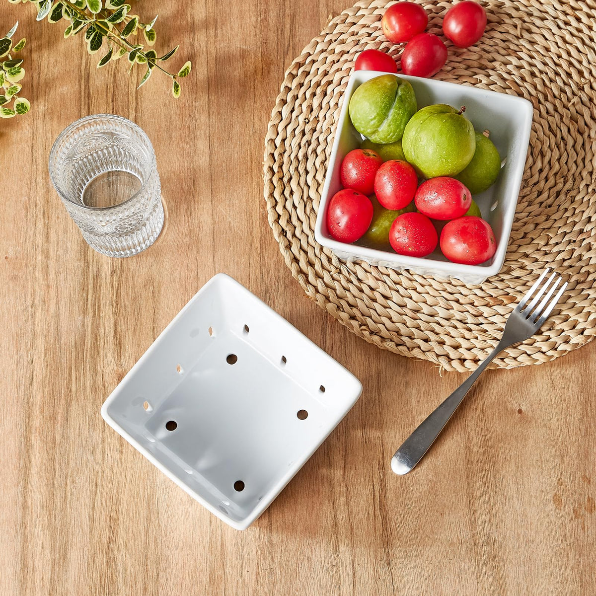 ONEMORE stoneware berry holder drains water while presenting berries attractively.