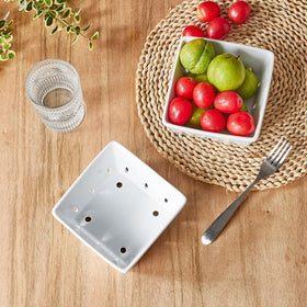 ONEMORE stoneware berry holder drains water while presenting berries attractively.