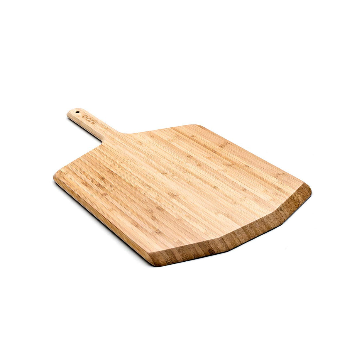 Ooni 12-inch bamboo pizza peel in use over oven for smooth transfer