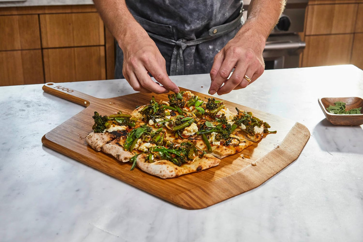 Ooni bamboo pizza paddle doubles as a serving board.