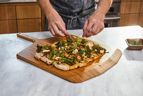 Ooni bamboo pizza paddle doubles as a serving board.