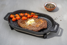 Ooni Grizzler Pan pre-seasoned cast iron ready for versatile cooking.