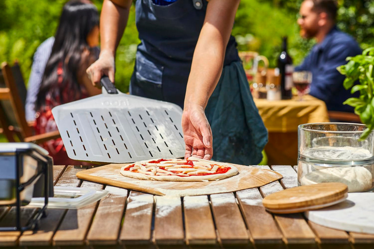 Ooni wooden pizza peel with smooth surface reduces sticking.