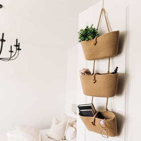 OrganiHaus boho nursery decor hanging baskets brighten walls.