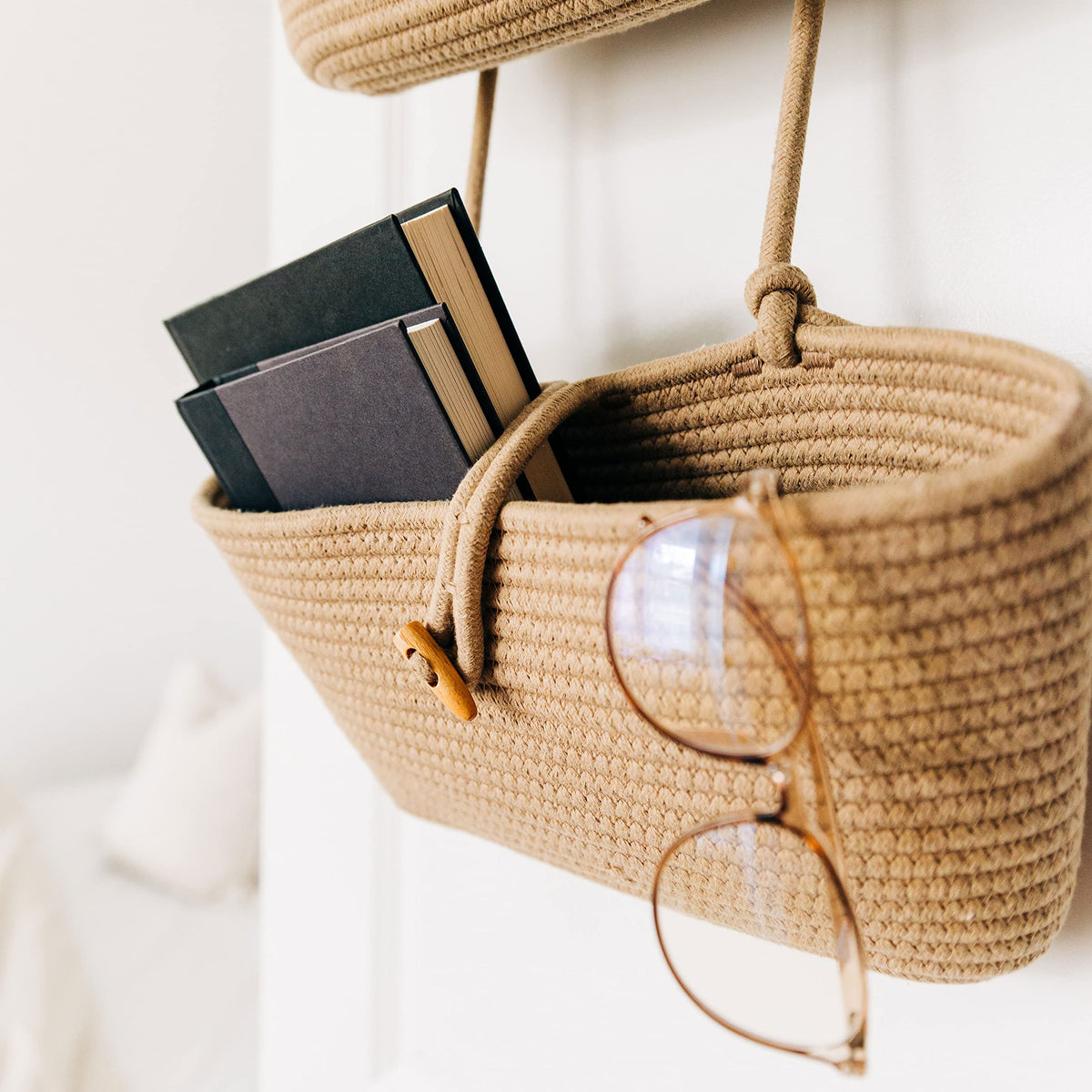 OrganiHaus wall storage organizer baskets mounted behind a door.