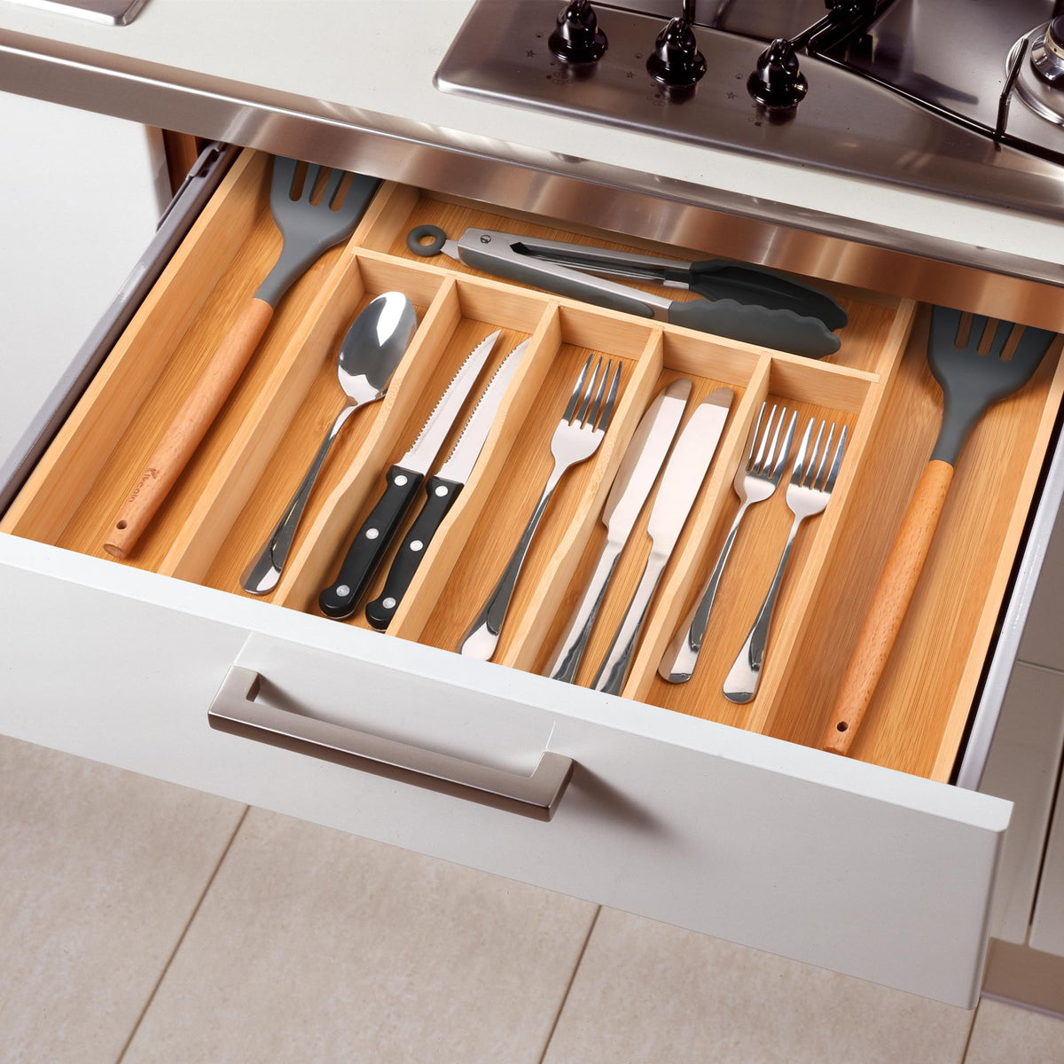 Space for large utensils like spatulas and ladles in deep compartments