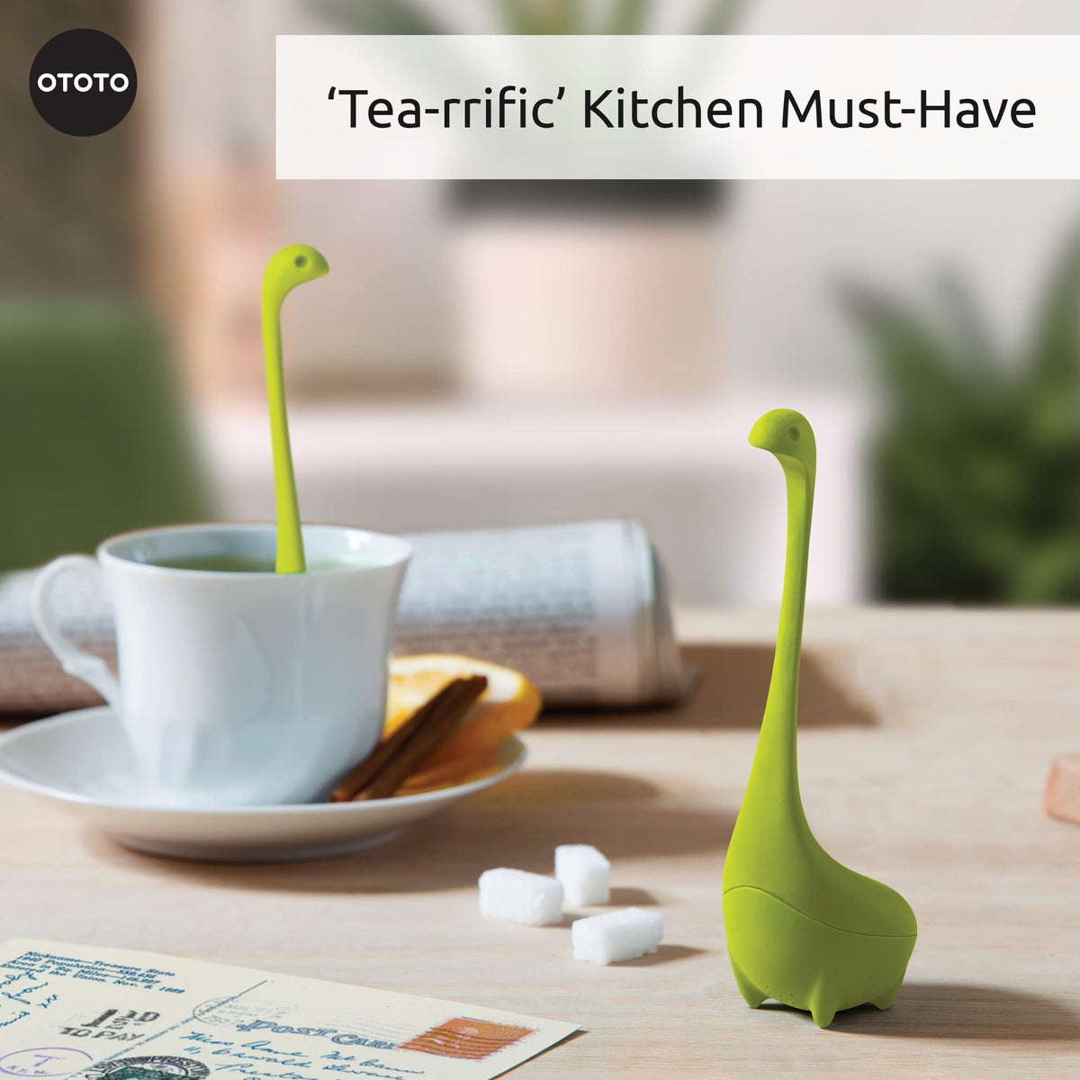 OTOTO Nessie dinosaur infuser perched in mug while brewing aroma.