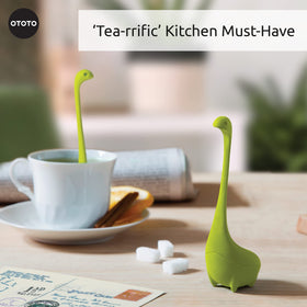 OTOTO Nessie dinosaur infuser perched in mug while brewing aroma.