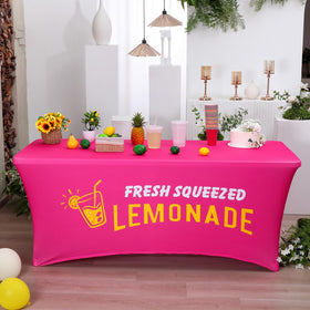 Oudain summer beach picnic setup with bright hot-pink tablecloth.