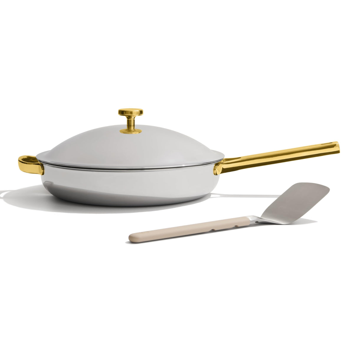 Our Place Titanium Always Pan Pro with spatula-rest showing easy access and clean countertops.