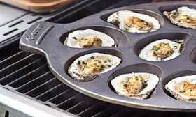 Outset oyster serving tray in cast iron for rustic presentation and heat retention.